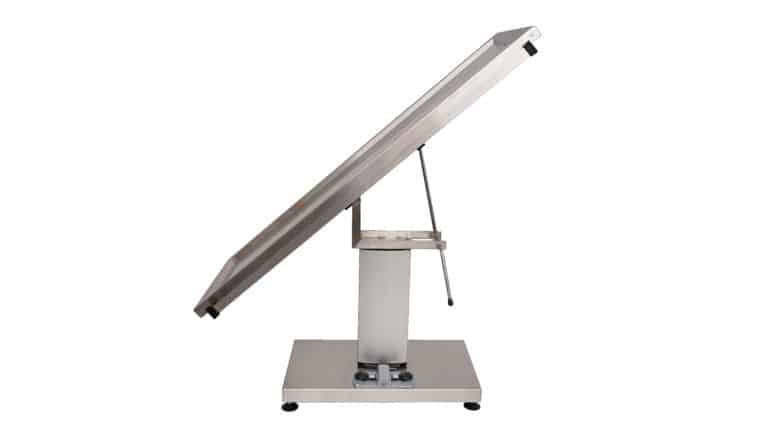 Surgery table with central electric column and two evacuation holes