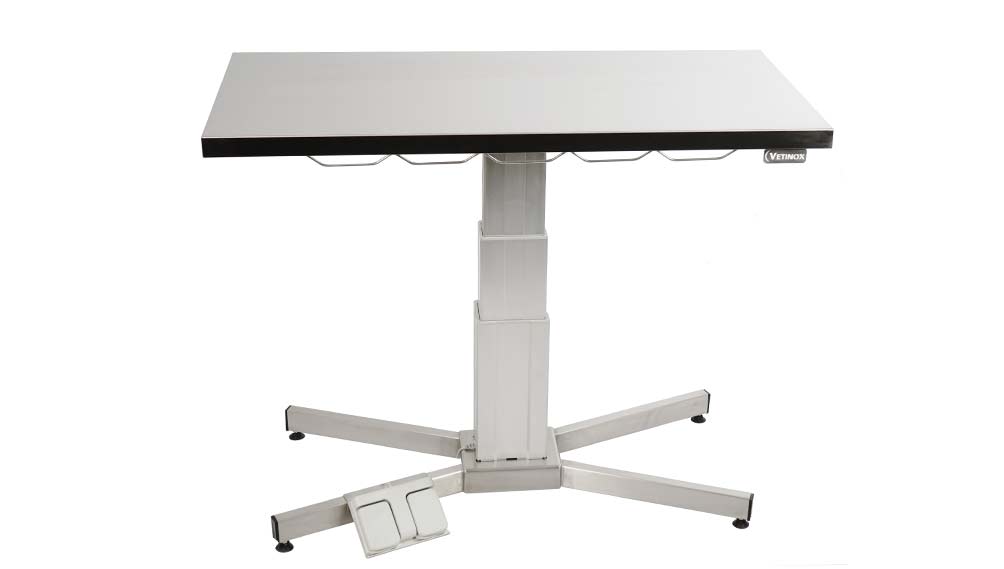 Examination table with central electric column and flat top