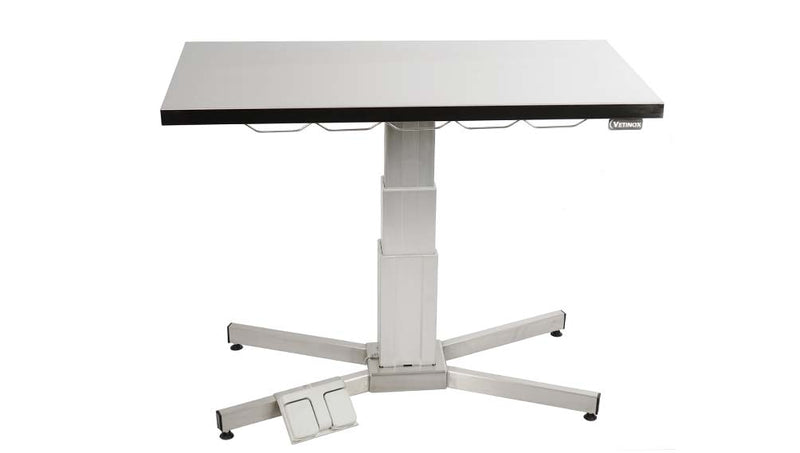 Examination table with central electric column and flat top