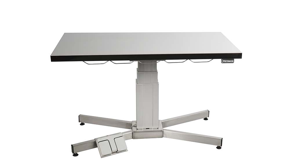 Examination table with central electric column and flat top